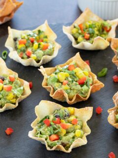 Avocado Wonton bites garnished with cilantro and bell pepper