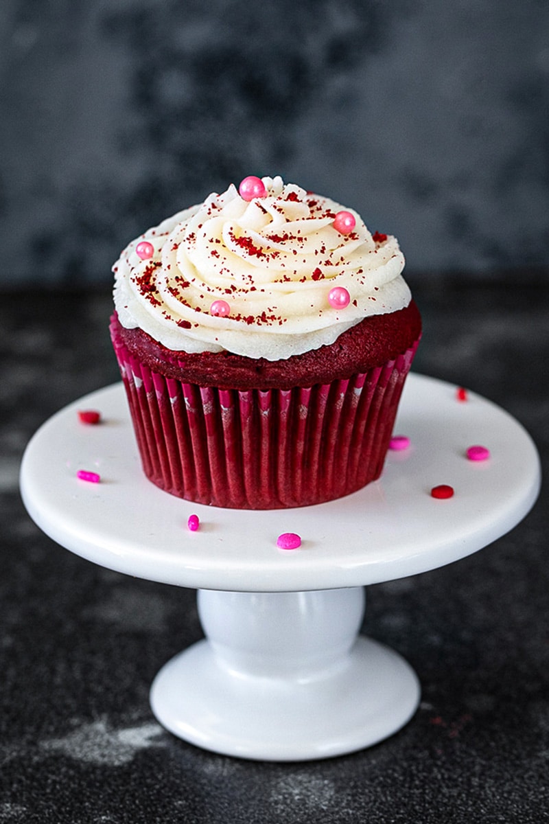 Eggless Cupcake on a stand garnished with sprinkles
