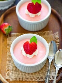 Eggless Strawberry Mousse with strawberry on top and mint leaves