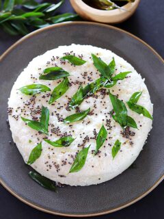 Khatta Dhokla on a plate with green chilies