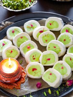 Pista Mithai roll with diya on a plate
