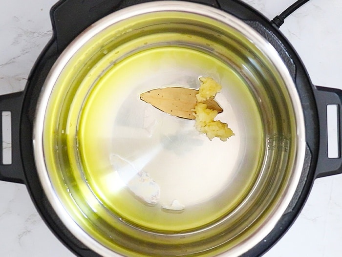 Add oil and bay leaf